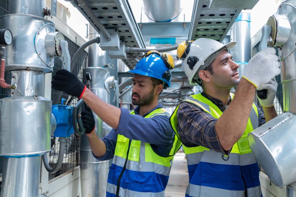 engineer inspects the water heater pump system